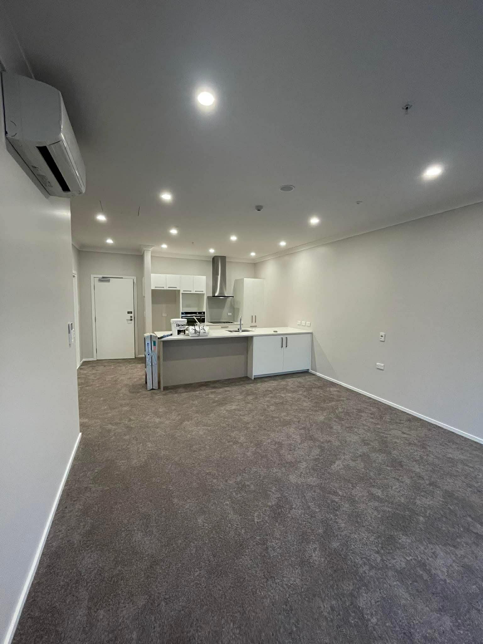 Interior painting fresh white walls in open plan apartment — Renoval Pro NZ Wellington