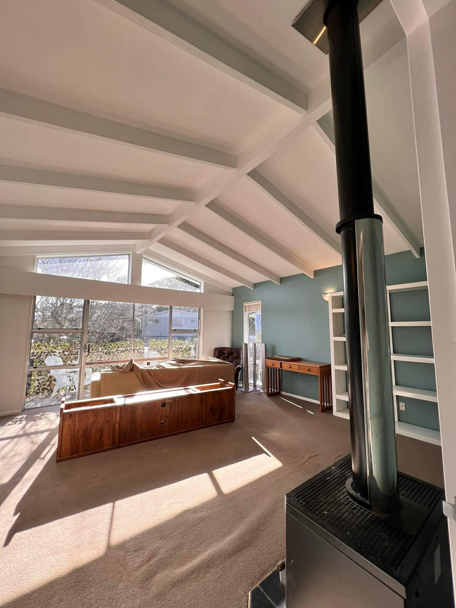Interior painting with white painted beams and teal feature wall — Renoval Pro NZ Wellington