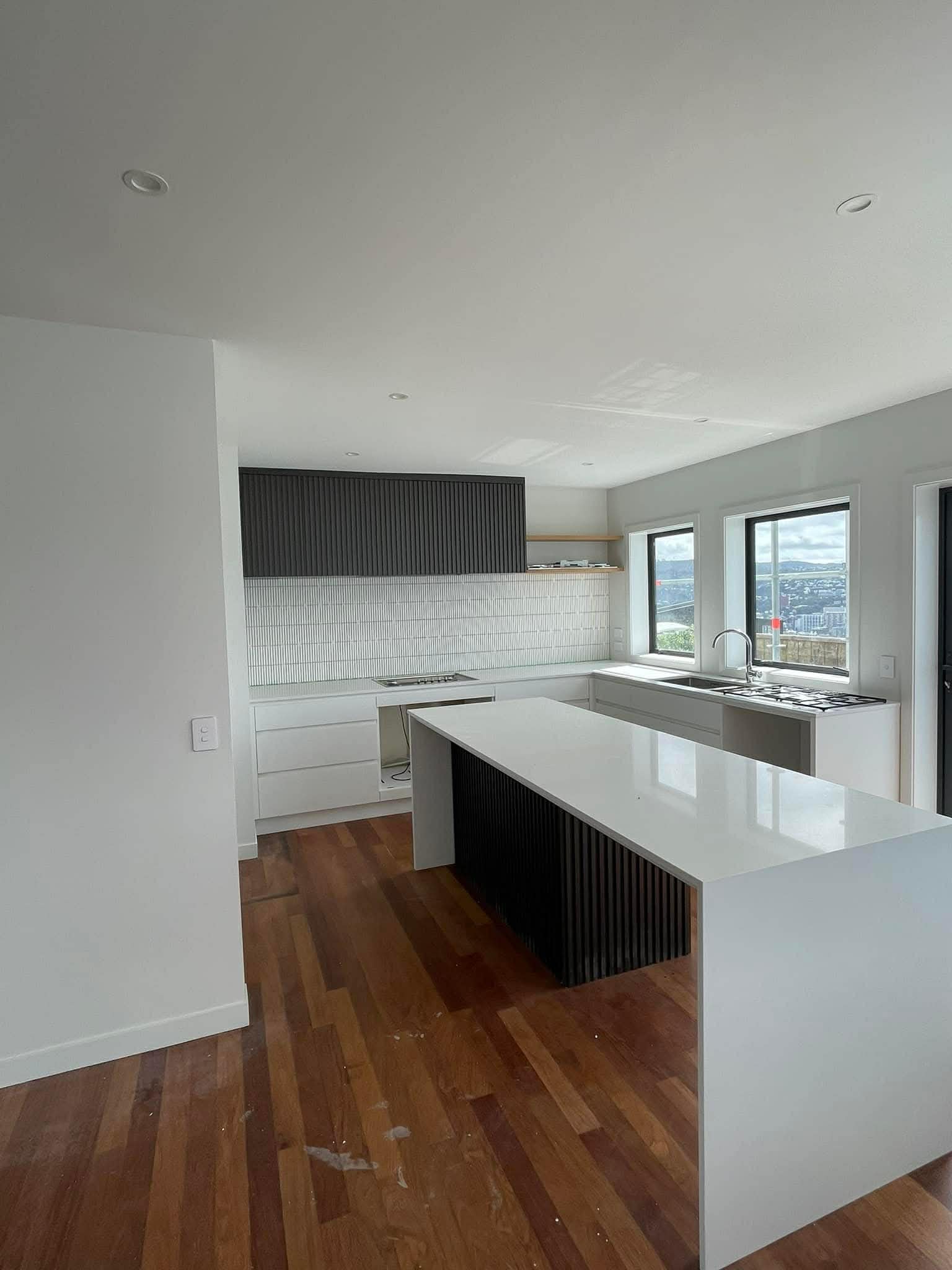 Kitchen renovation with painted black cabinetry and stone benchtop — Renoval Pro NZ Wellington