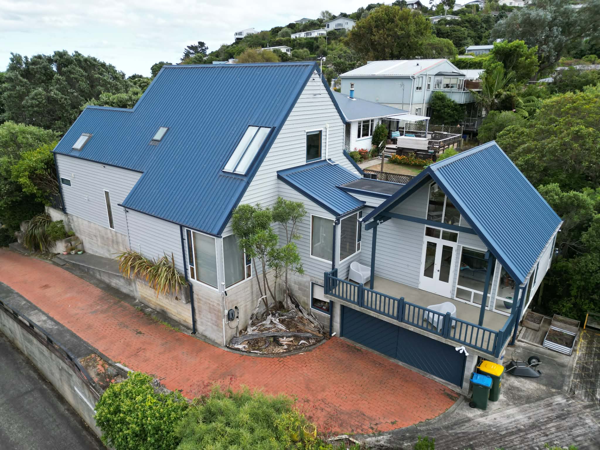 Wellington home aerial view with blue roof and fresh exterior paint — Renoval Pro NZ